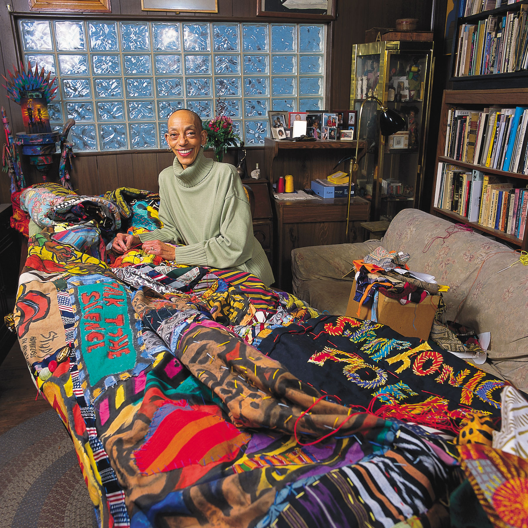 Aminah Robinson with a colorful quilt